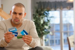 Hispanic man choosing credit cards